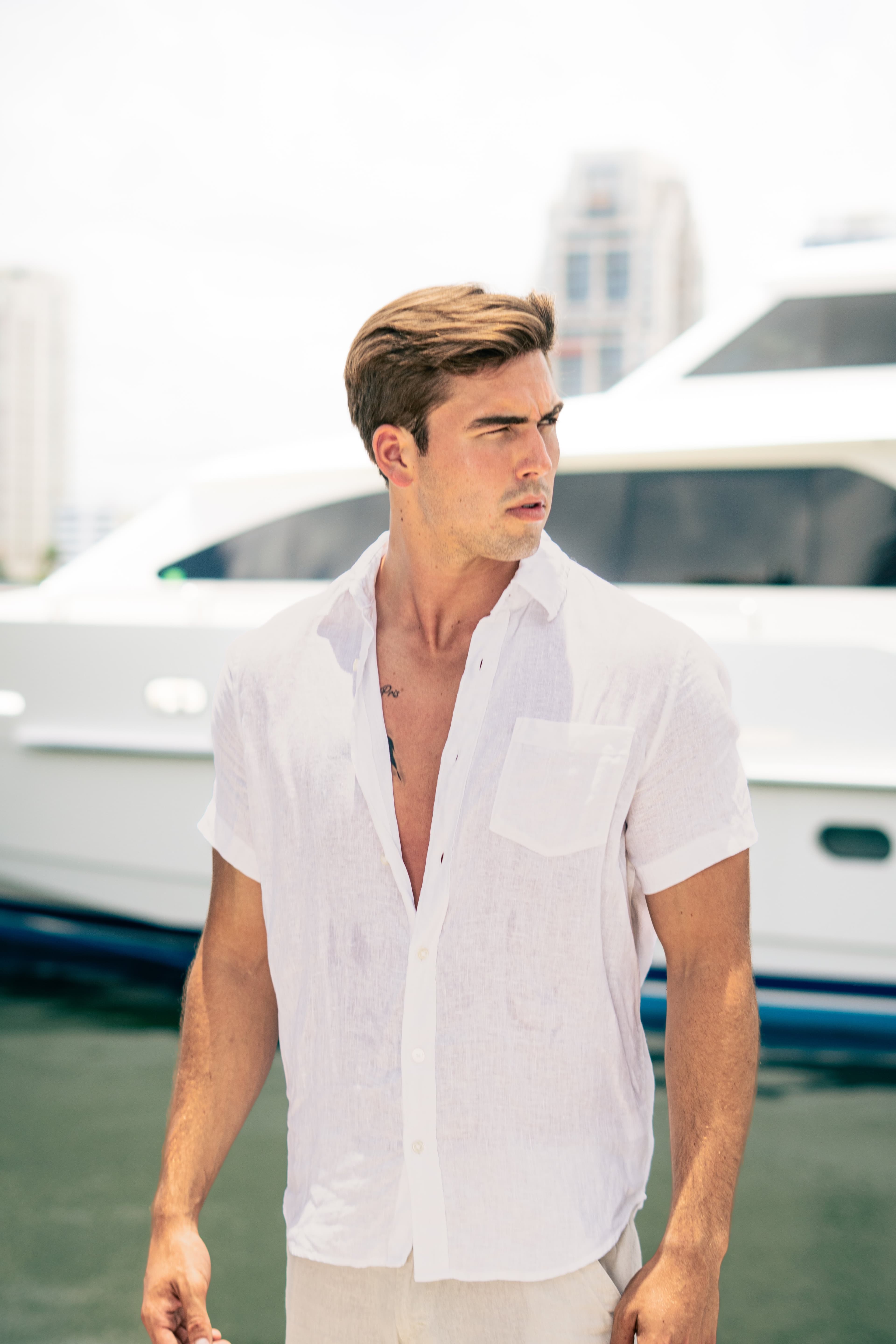 Christian Utne on the marina in white linen shirt