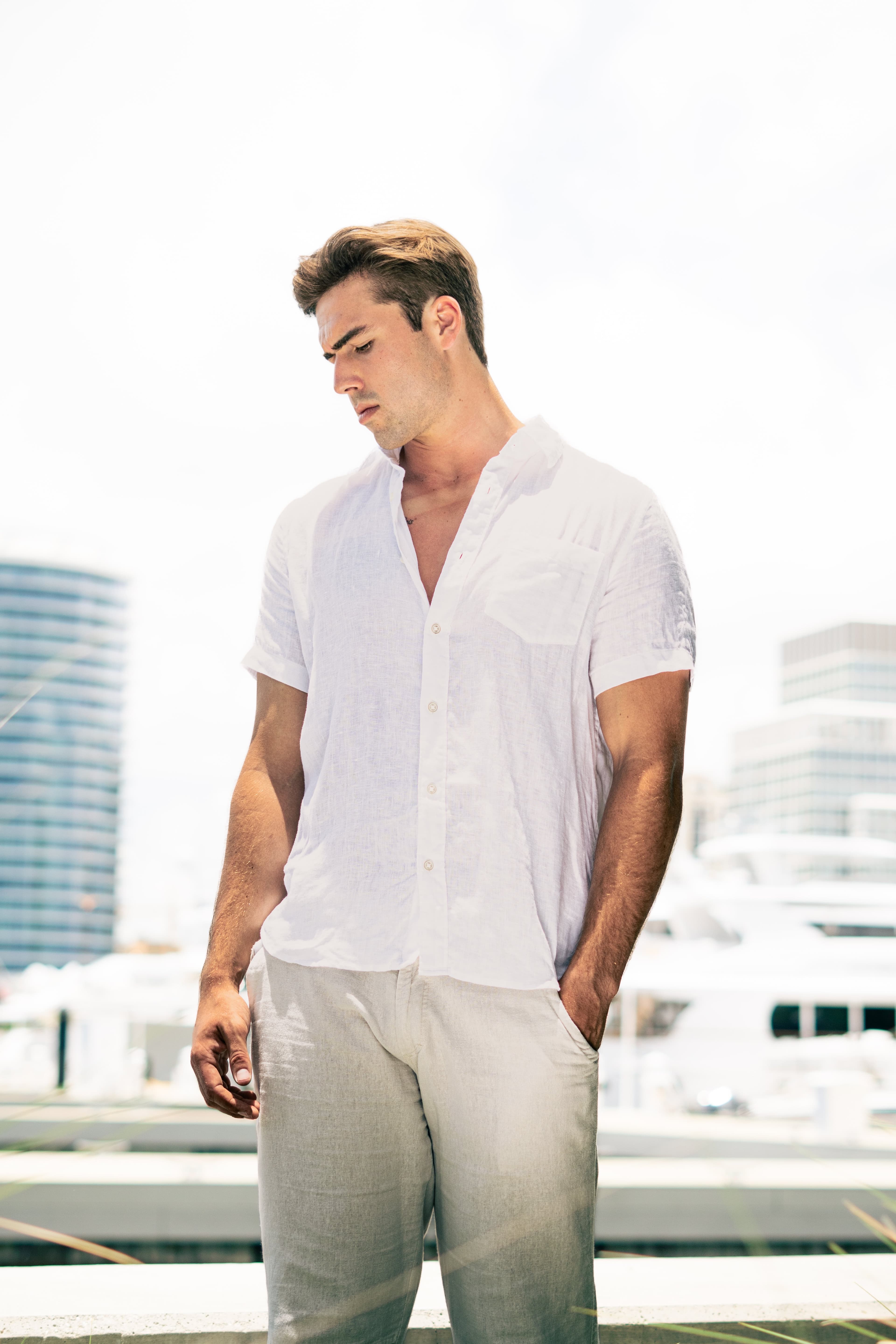Christian Utne in white shirt and linen pants at the marina